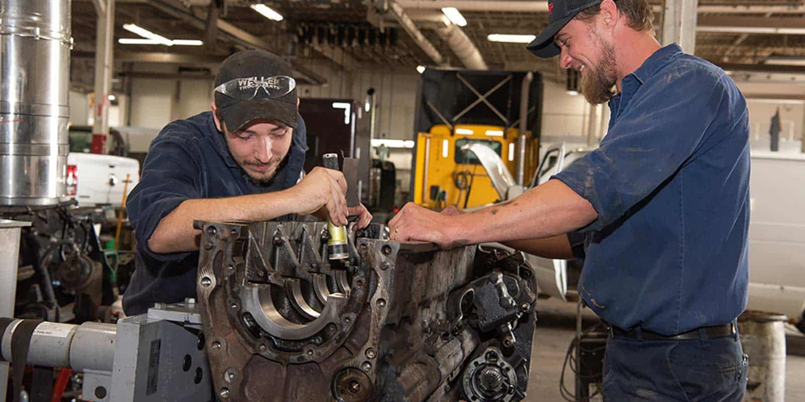 Industrial truck repair and maintenance services at Universal Truck. Skilled technicians working on large truck engines.